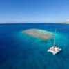 Private catamaran anchored in turquoise french polynesia