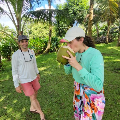 Couple drinking coconuts cocktails during sunset