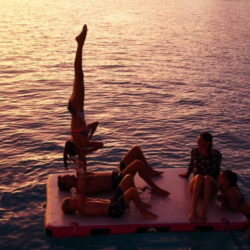 Yoga on the catamaran deck at sunrise