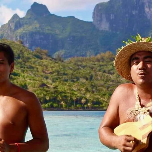 Local musician playing ukulele on a private tour
